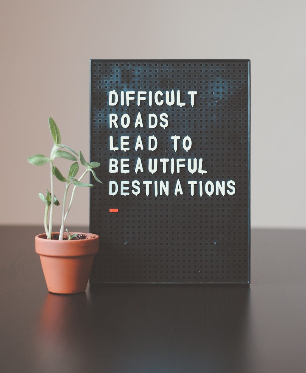 Photo by Nik difficult roads lead to beautiful destinations desk decor