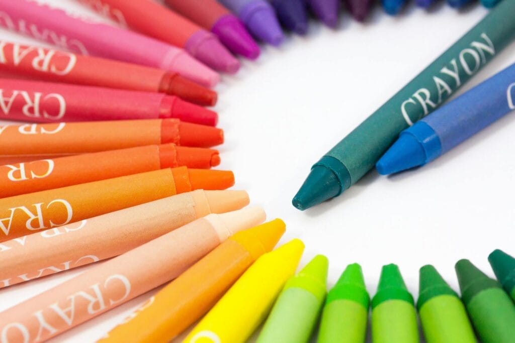 A vibrant semi-circle display of colorful crayons on a white background.