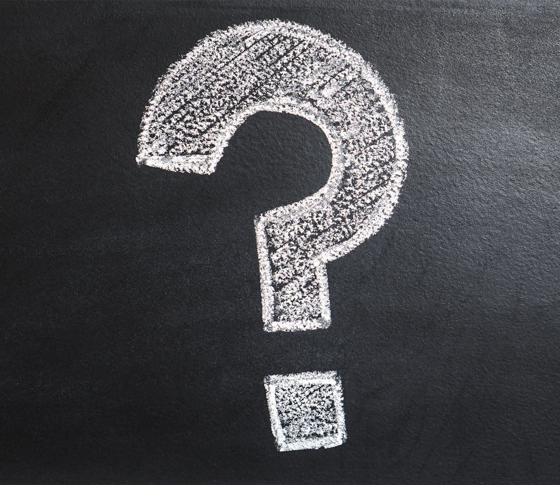 A conceptual image featuring a question mark drawn on a chalkboard, ideal for problem-solving contexts.